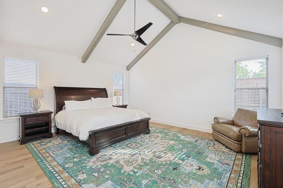 Bedroom featuring beamed ceiling, high vaulted ceiling, light wood-type flooring, and ceiling fan