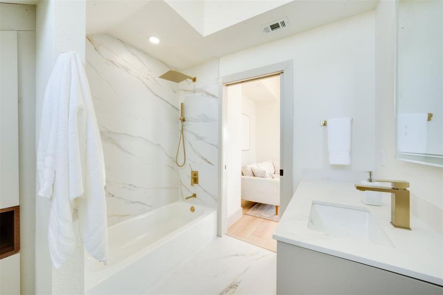 Bathroom with vanity, wood-type flooring, and shower / bathtub combination