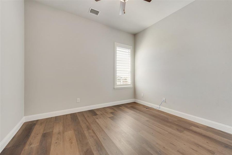 Bedroom featuring ceiling fan and hardwood / wood-style floors