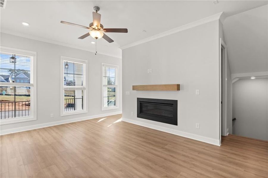 The fireplace, with its clean lines and contemporary design, contrasts beautifully with the textured shiplap surrounding it. NOT actual home. Photos of previously built Grayton floorplan.