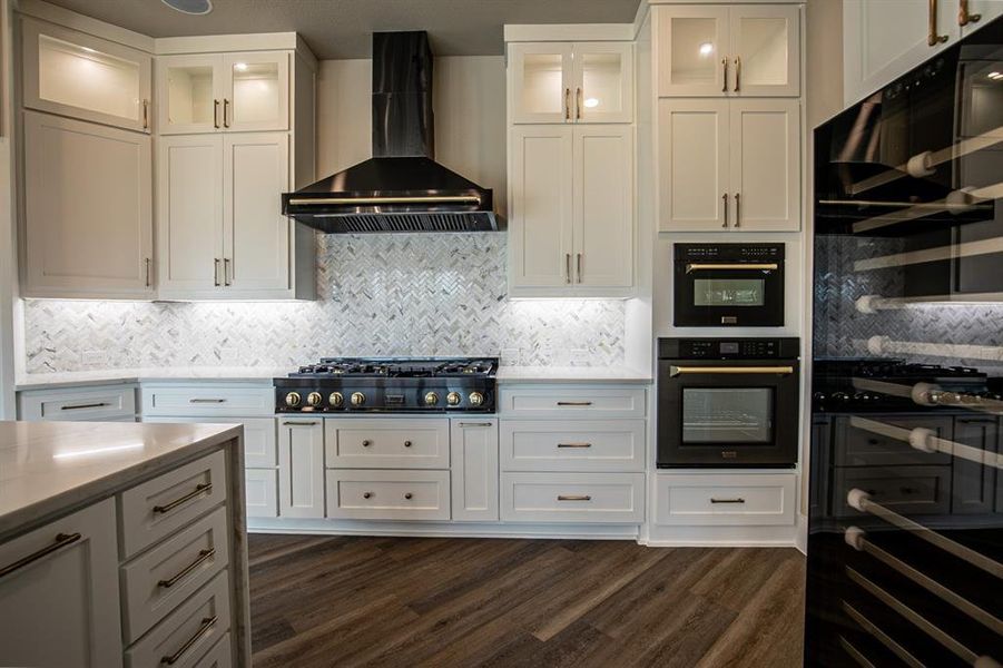 Kitchen with 6 burner gas cooktop, wine refrigerator & wall chimney range hood