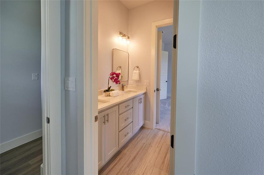 Bathroom featuring hardwood / wood-style floors and double vanity