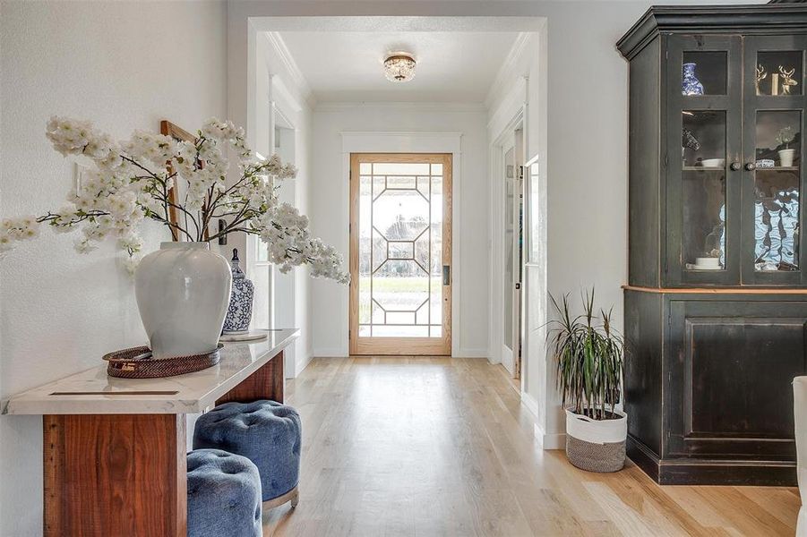 Elegant entryway with white oak floors leading into the open-concept living area.