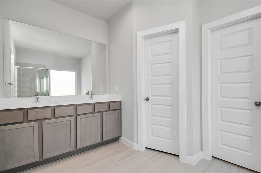 Indulge in a spa-like retreat within the confines of this primary bathroom. Sample photo of completed home with similar floor plan. Actual colors and selections may vary.