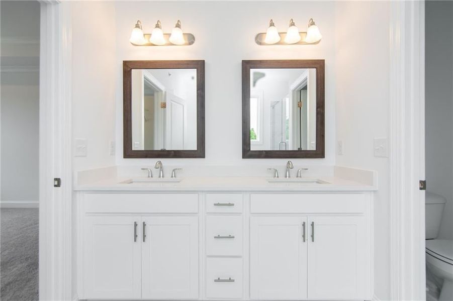 Master Bathroom featuring double vanity and toilet not the actual unit