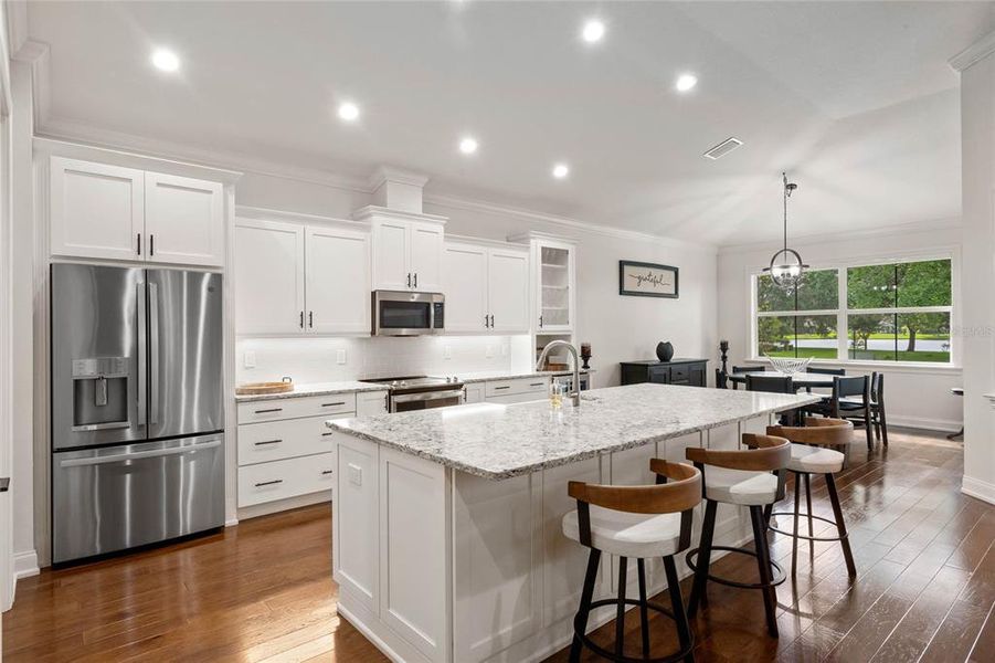 Gourmet Kitchen with White Cabinetry that features undermount task lighting