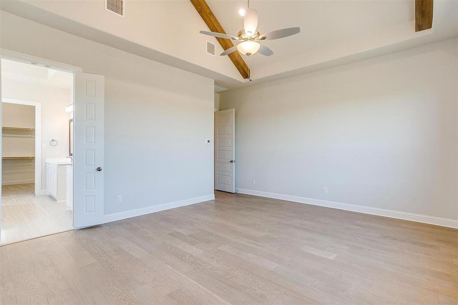 Spare room featuring ceiling fan and light wood-type flooring