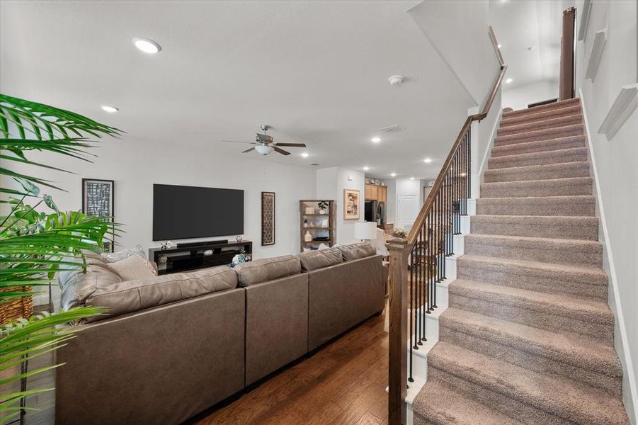 Living room featuring ceiling fan and dark hardwood / wood-style floors