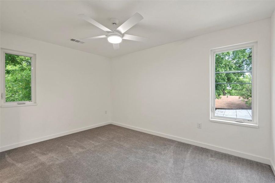 Empty room with carpet and ceiling fan