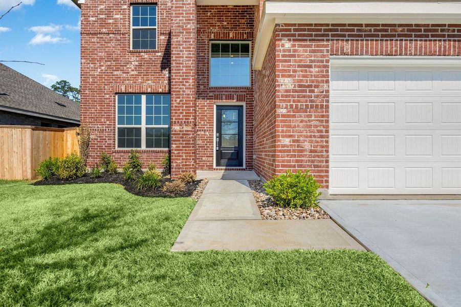 Lush green landscaping, and meticulously manicured lawn