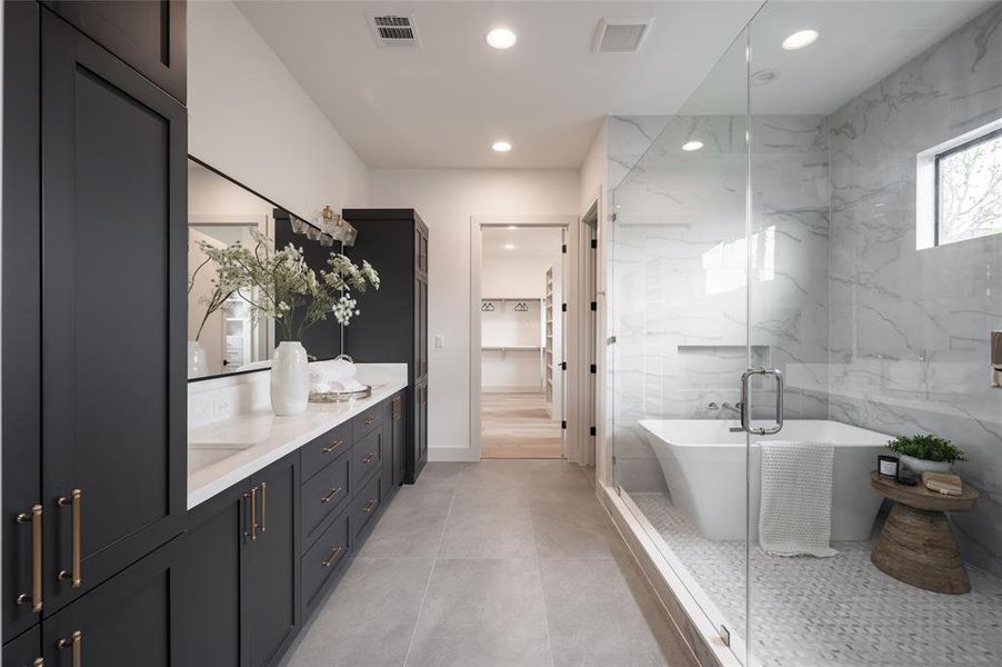 The exquisite spa bathroom beckons with a wide double vanity, aprivate water closet and a windowed wet room surrounded by an array of premium tiles.