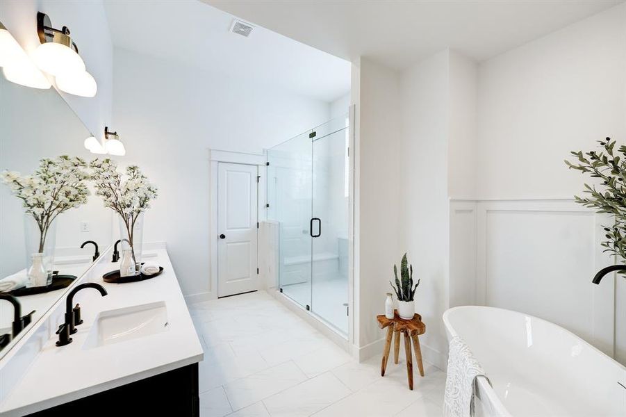 Ensuite Oasis: Featuring dual vanities, a spacious glass-enclosed shower, and a luxurious soaking tub for the ultimate relaxation.