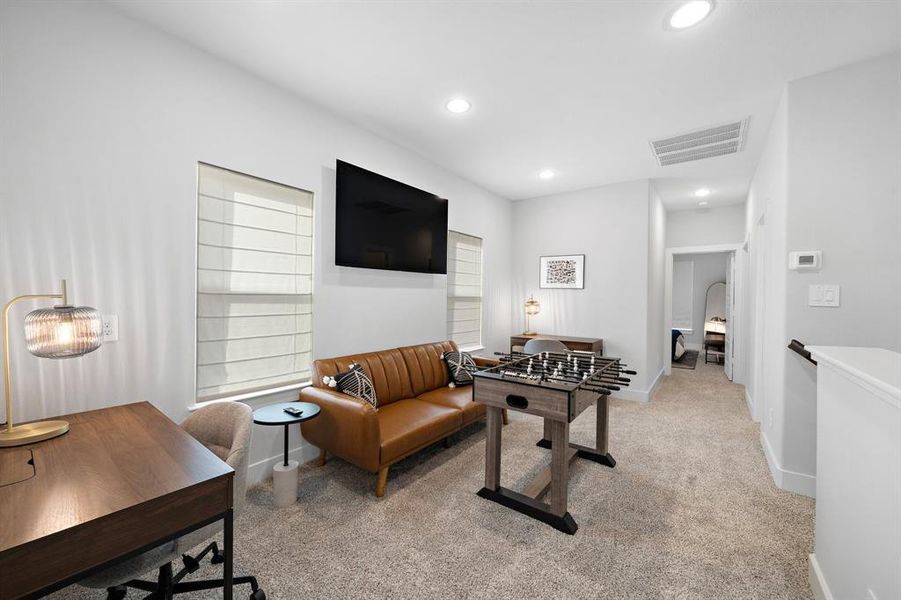 Large game room bathed in natural light, offering a flexible layout for leisure and family time.