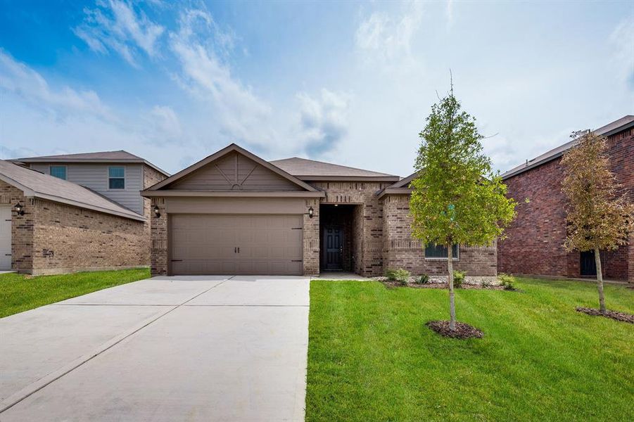 View of front of house featuring a front yard and a garage