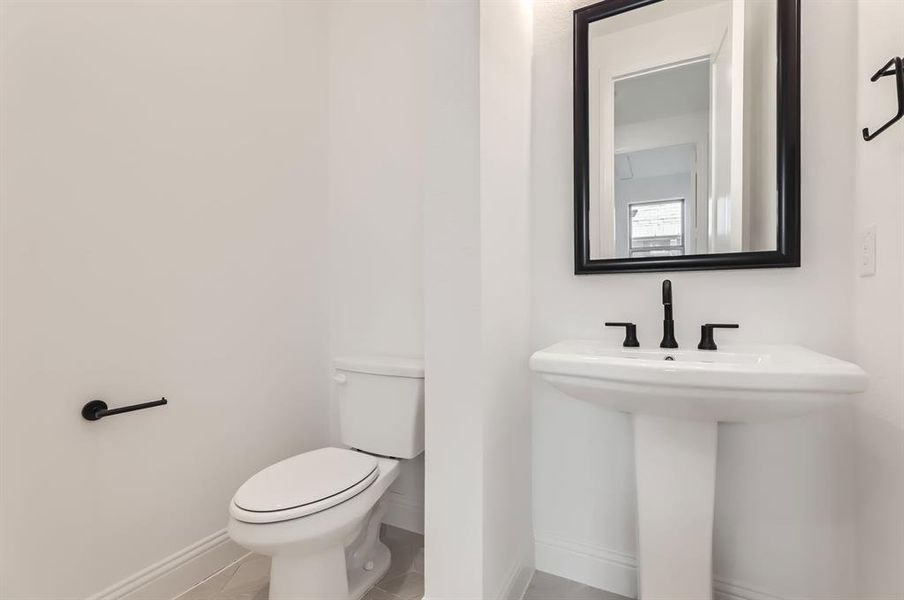 Bathroom featuring toilet and tile patterned flooring