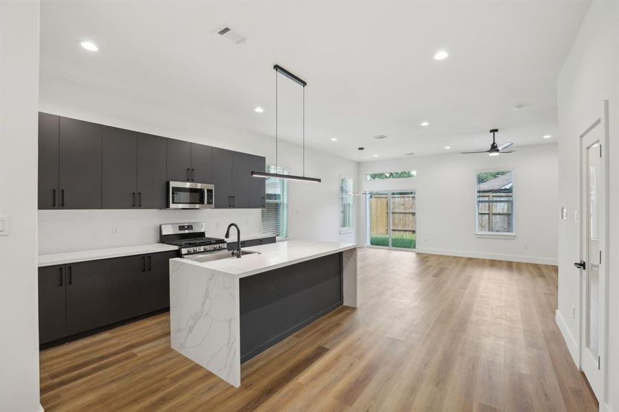 Open concept kitchen and living room flow with tons of natural light