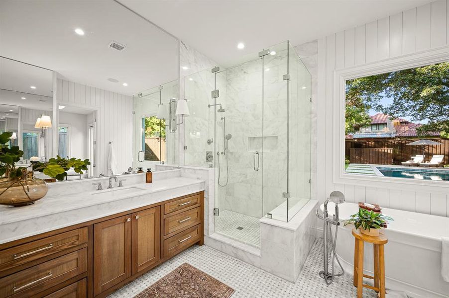 Bathroom with vanity, plus walk in shower, plenty of natural light, and tile patterned floors