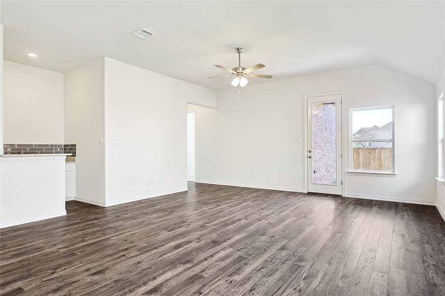 Additional living space with lofted ceiling, ceiling fan, and dark hardwood / wood-style floors