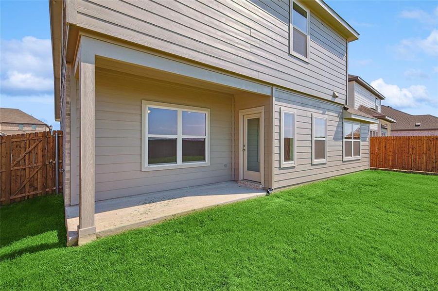 Rear view of property with a patio area and a yard