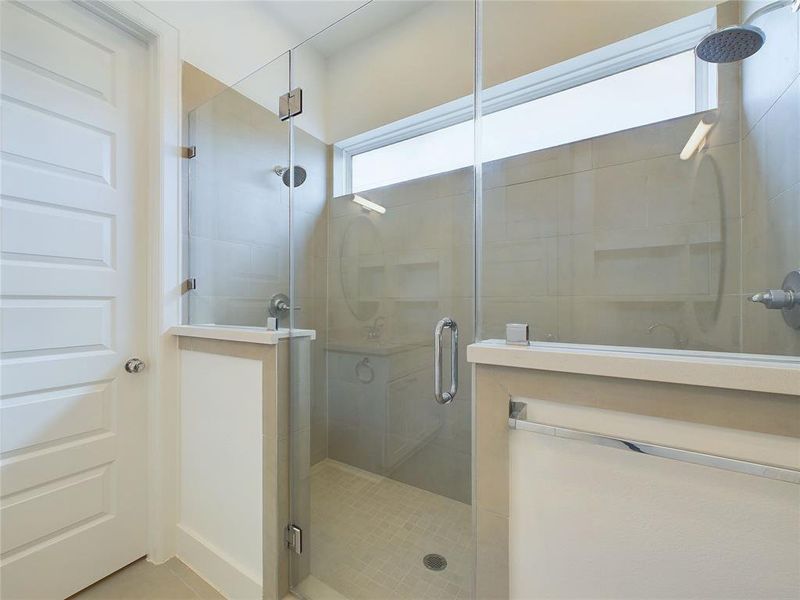 Primary bath with a spacious walk-in shower and two shower heads