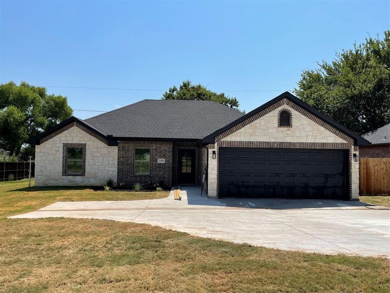 Single story home with a front lawn and a garage