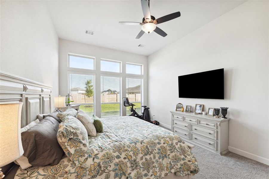 The primary bedroom has triple windows with upper transom accent windows that over look the back yard.