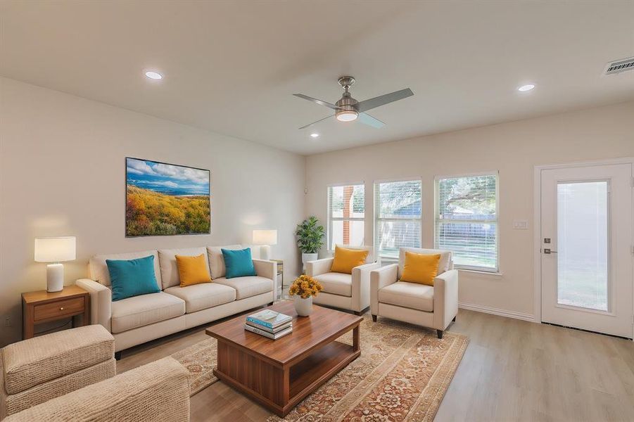 Living room featuring light hardwood / wood-style floors and ceiling fan