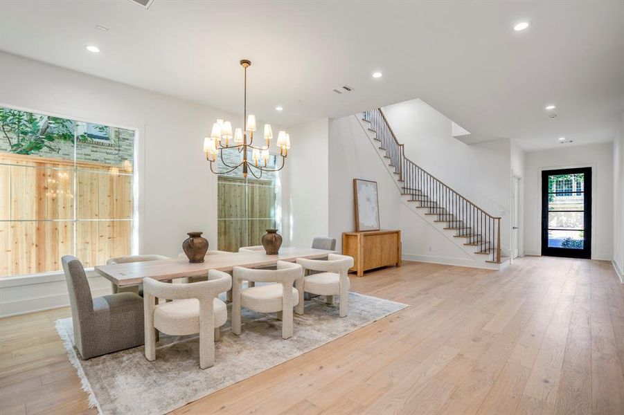 Let's take you through the first level of this incredible custom home. A formal dining space is past the foyer and spacious enough for the largest gatherings.