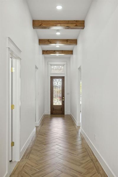 Entryway featuring beamed ceiling and parquet floors