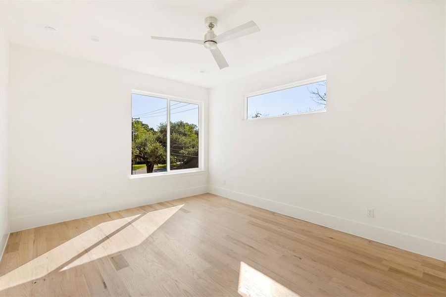 Unfurnished room with light wood-type flooring and ceiling fan