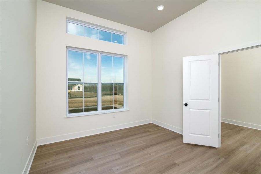 Spare room featuring wood-type flooring