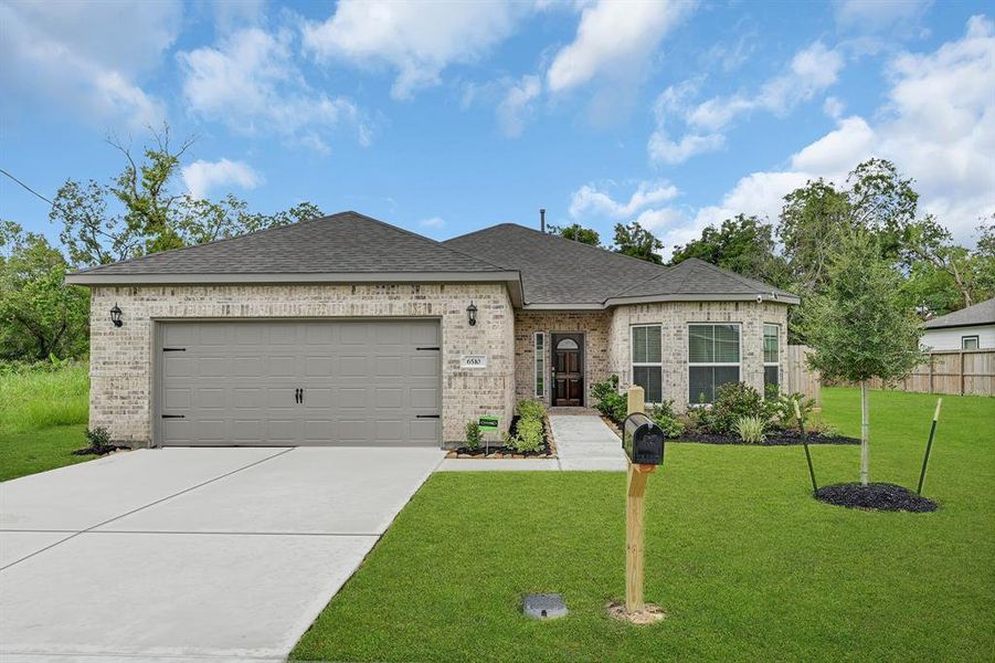 This is a single-story, brick veneer home featuring a two-car garage, landscaped front yard, and a welcoming entrance with a pathway leading to a wood and glass front door.