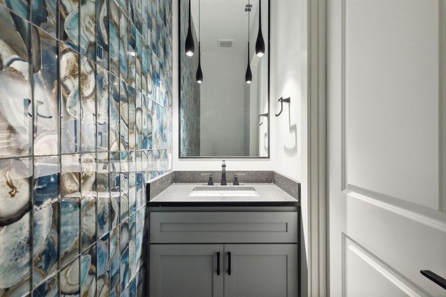 Bathroom off flexible space with vanity