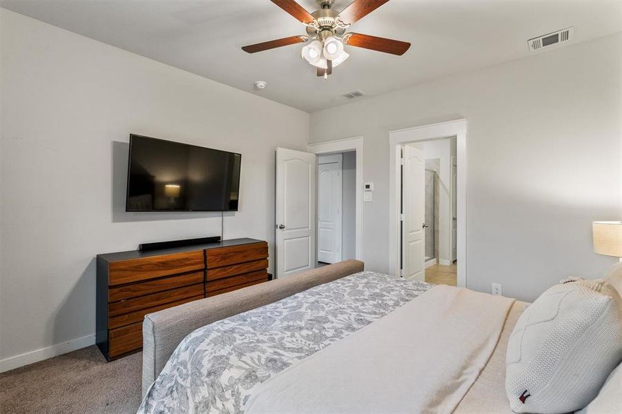 Bedroom with light carpet and ceiling fan