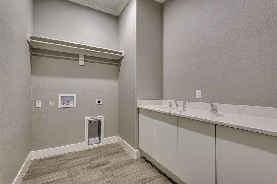 Laundry room with hookup for a washing machine, hookup for an electric dryer, and light hardwood / wood-style flooring