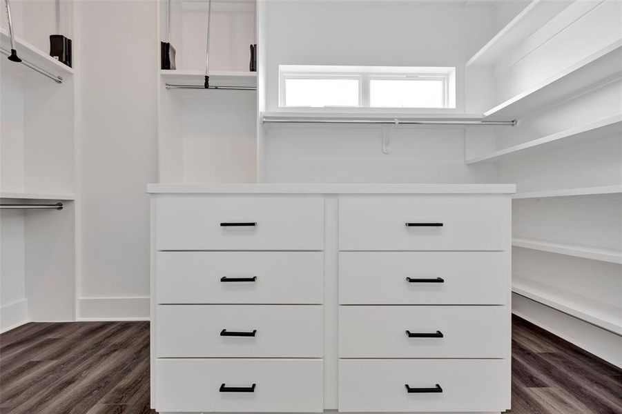 The primary bedroom boasts a huge walk-in closet, providing expansive storage space and convenience.