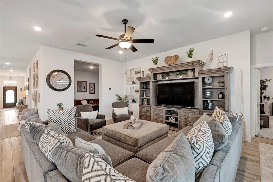 Spacious Living Area - Expansive room with a view of the front door, media room entry, and primary bedroom entry. Perfect for relaxing and entertaining.