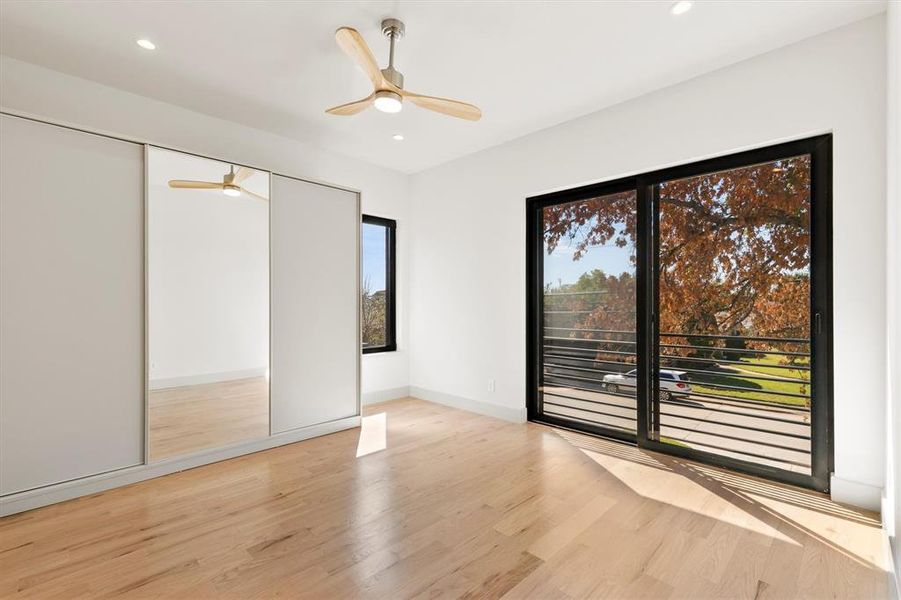 Unfurnished bedroom featuring light wood-type flooring, ceiling fan, and a closet