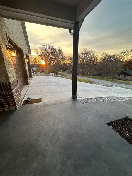 Patio terrace at dusk with a garage