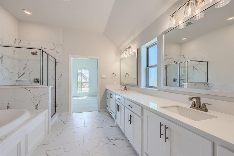 Bathroom with independent shower and bath, dual vanity, tile patterned floors, and vaulted ceiling