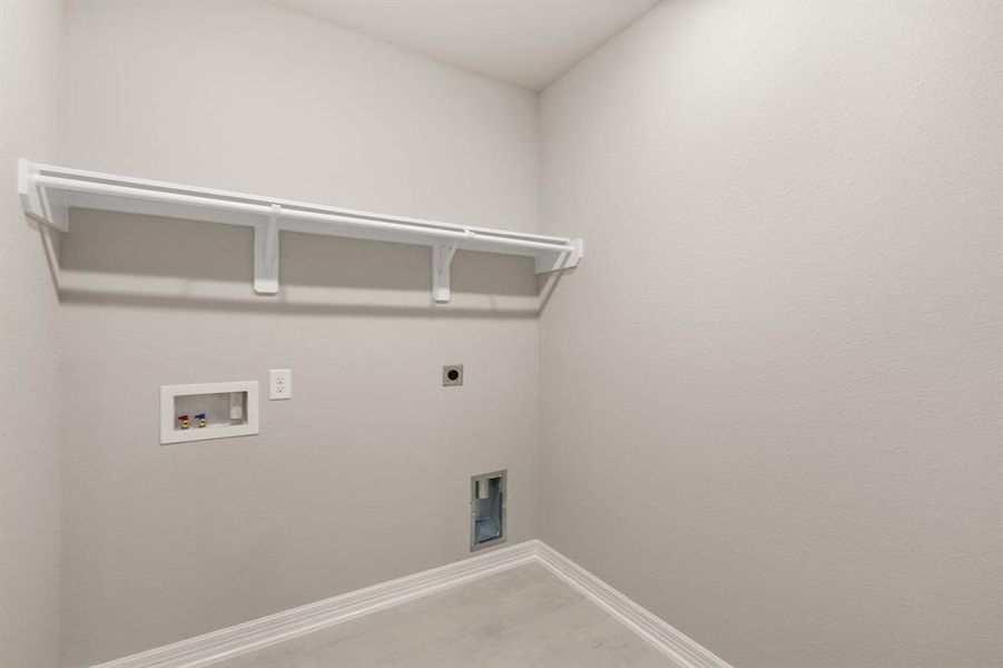 The laundry room layout is carefully planned for optimal workflow with designated areas for washing, drying, and storing.