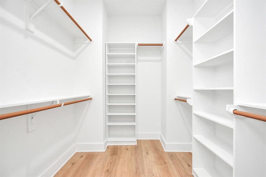 Spacious walk-in closet in second primary room, providing organized storage and convenience.