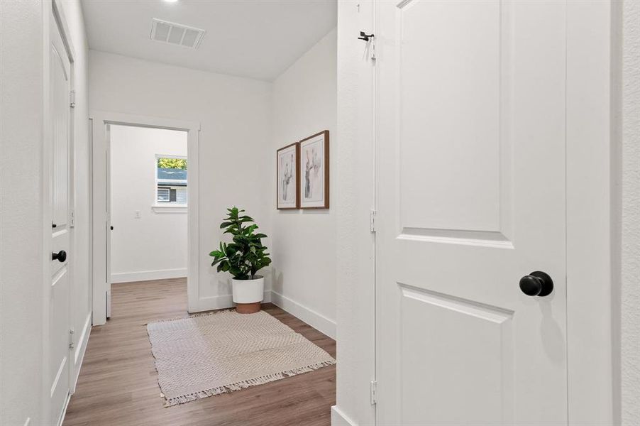 Hallway with light hardwood / wood-style flooring