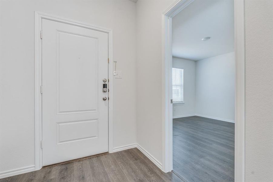 Entrance foyer with hardwood / wood-style flooring