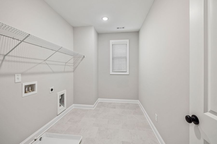 Convenient laundry room located next to the primary bedroom