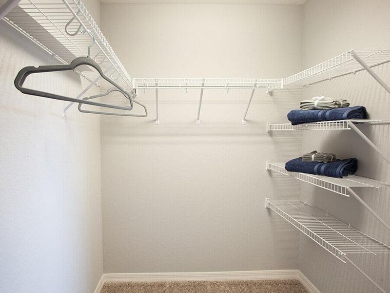 Built-in storage includes this walk-in wardrobe with linen stack in the owner`s suite - Parker home plan by Highland Homes
