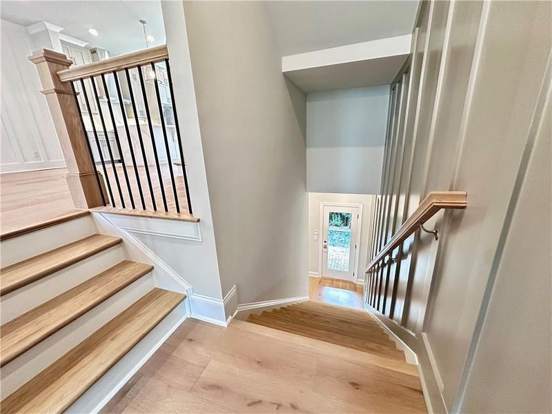 Split level staircase take you down to the terrace level featuring fourth bedroom plus backyard access