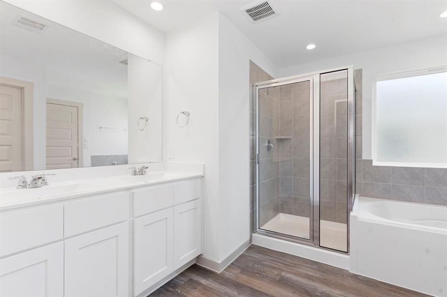 Luxurious Primary Suite was made for two! Beautiful Carefree Vinyl Wood Floors, Large Shower with Tile Surroundings! **Representative Photo of Plan only and may vary as built**