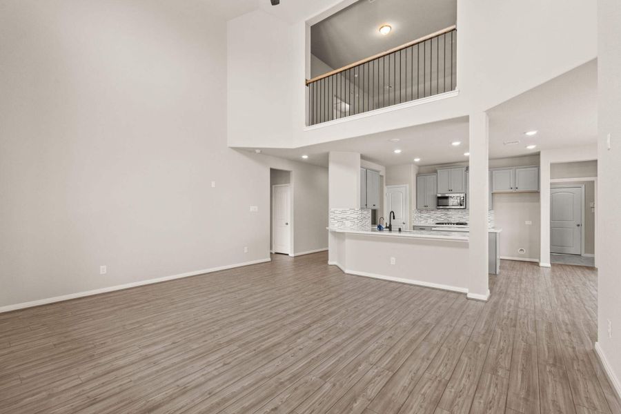 The kitchen overlooks the two story family room and upstairs game room.