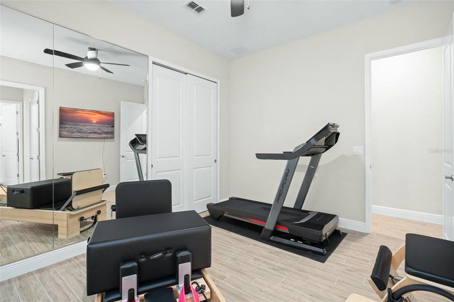 Third bedroom functions as a home gym or spacious bedroom.